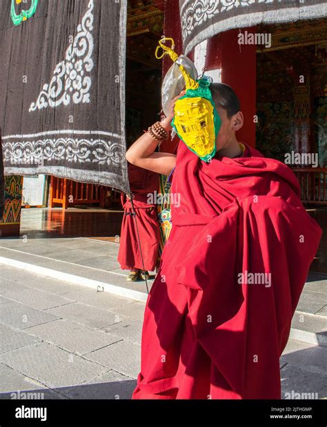 Young Novice Tibetan Buddhist Monk Wearing Red Robes Welcoming