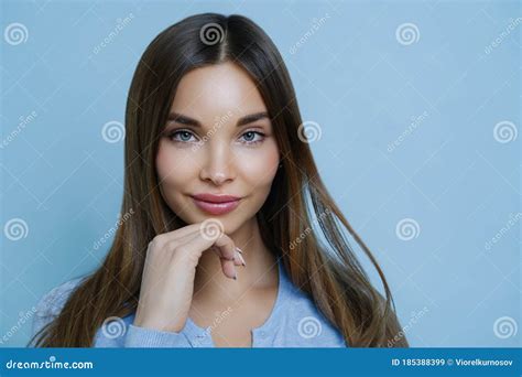 Close Up Shot Of Nice Looking Young European Woman Touches Jawline