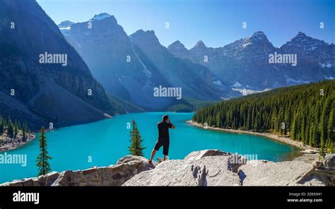 Moraine Lake Rockpile Trail In Summer Sunny Day Morning Tourists