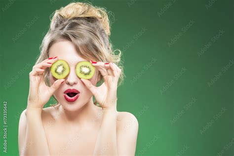 Kiwi Fruit Series Smiling Caucasian Nude Model Making Faces While Posing With Two Kiwi Slices