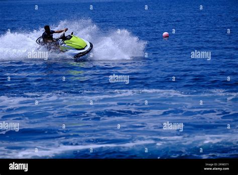 Young Man With Beard Riding Jet Ski In A Sunny Summer Day Stock Photo