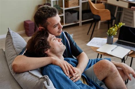 Premium Photo High Angle Portrait Of Affectionate Same Sex Couple Embracing On Couch And