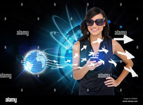 Glamorous Brunette Using Smartphone With Earth And Arrows Stock Photo