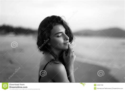 Portrait Of A Young Beautiful Woman With Long Curly Hair At The Seaside