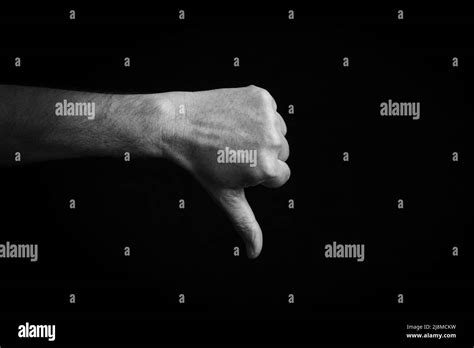 Dramatic Black And White Image Of Thumbs Down Emoji Isolated On Black