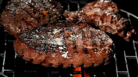 Spices Fall on a Grilled Beef Steak on a Metal Grate Over an Open Fire ...