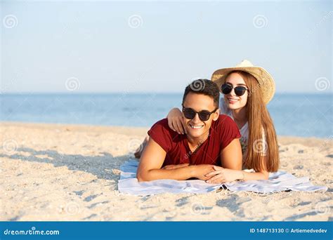 Happy Interracial Couple Newlyweds Lie In The Sun On Tropical Travel