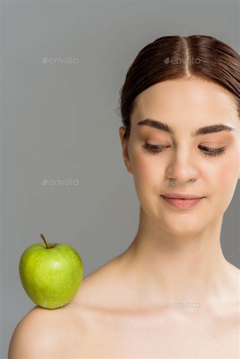 Brunette Nude Woman With Green Apple On Shoulder Isolated On Grey Stock Photo By LightFieldStudios