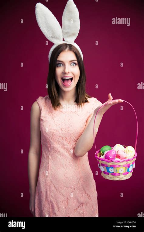 Cheerful Young Woman With Bunny Ears And Easter Egg Basket Looking At