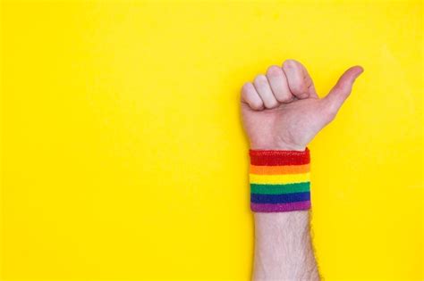 Premium Photo Thumbs Up Hand With Gay Pride Rainbow Flag Wristband On