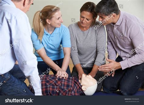 Woman Demonstrating Cpr On Training Dummy Stock Photo 370596695 ...