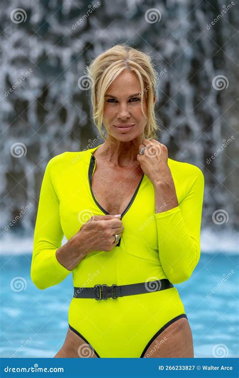 Lovely Mature Blonde Bikini Model Enjoys A Day Poolside At Home Stock