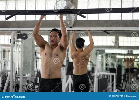 Fit Asian Man With Nude Torso Pull Up On Horizontal Bar In Gym Stock Image Image Of Healthy