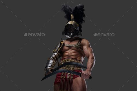 Aggressive Roman Gladiator With Naked Torso Dual Wielding Swords Stock