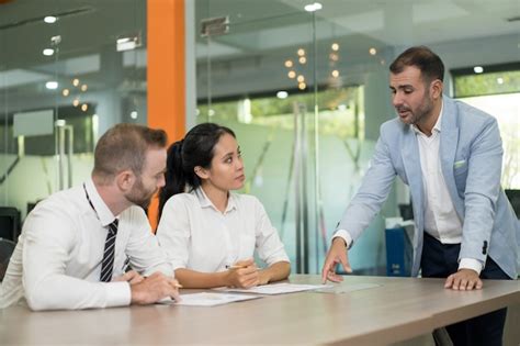 Free Photo Business Man Standing And Discussing Issues With Colleagues