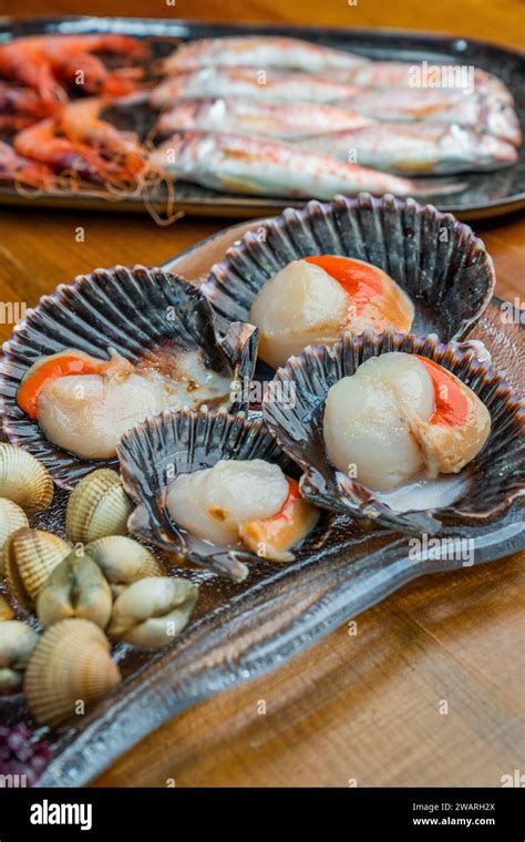 Three White Plates Featuring A Variety Of Succulent Seafood Including