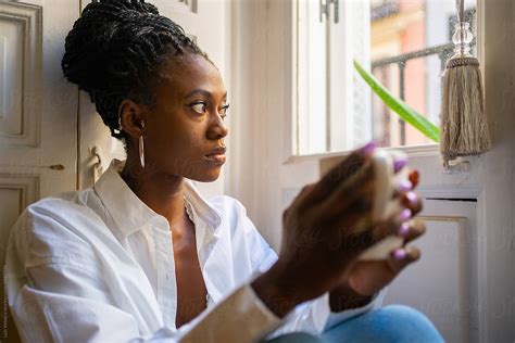 Cute Black Woman Warming Up Having A Hot Drink At Home By Stocksy Contributor Luis Velasco