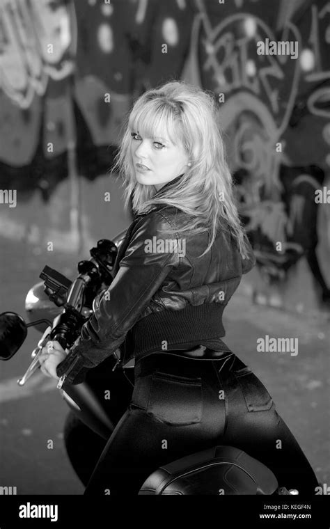 Beautiful Blonde Girl In Black With A Harley Davidson Motorcycle Stock Photo Alamy
