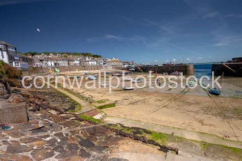 Mousehole Harbour With Boats Dried Out • Cornwall Photo Stock