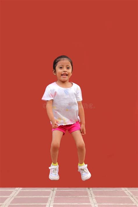 3 Year Old Latina Girl Jumps With Happiness Plays And Has Fun In Poverty Stock Photo Image Of