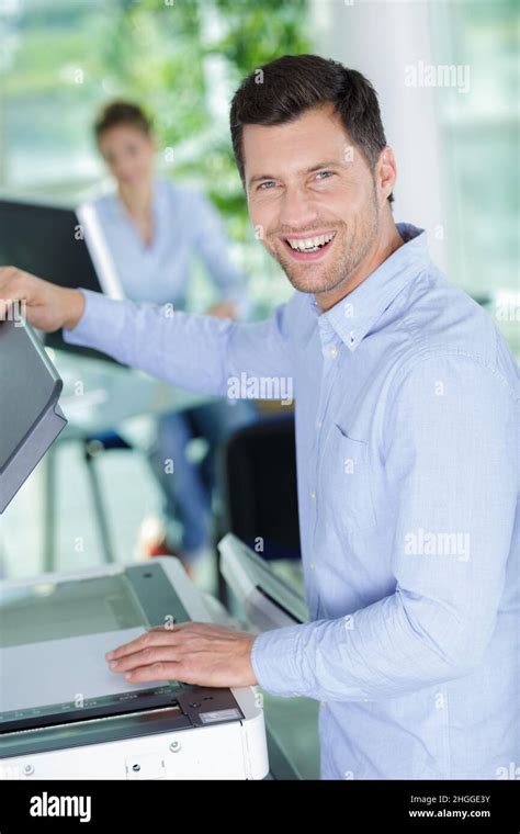 Happy Man Is Doing Documents Copies On Copying Machine Stock Photo Alamy