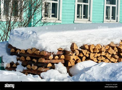 Wood Piled In A Woodpile Under The Snow In Winter Stock Photo Alamy