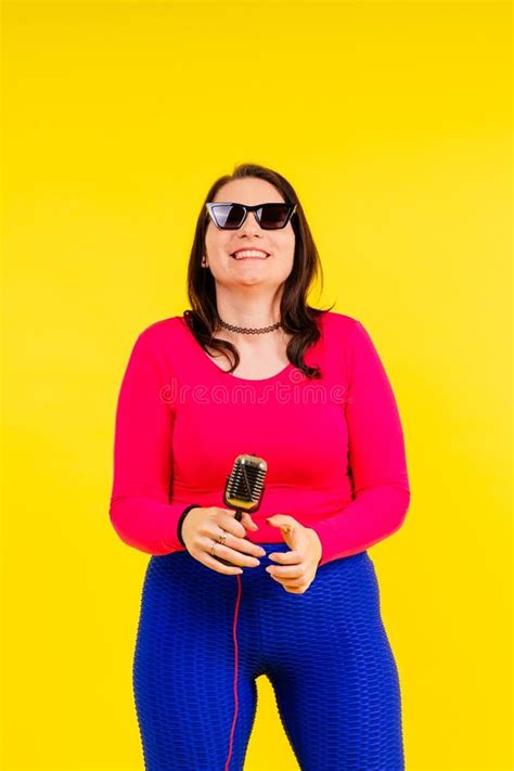 Smiling Brunette Woman With Microphone On Colored Studio Background Stock Image Image Of Belly