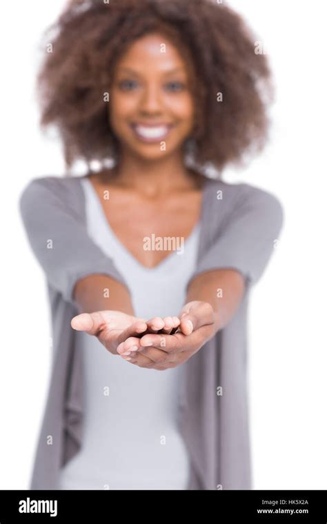Cheerful Brunette Holding Her Hands Out On White Background Stock Photo Alamy