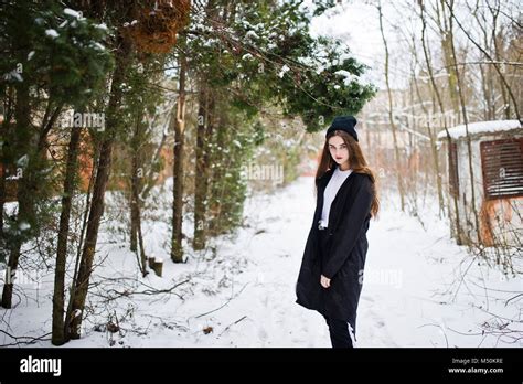 Fashionable Long Legs Brunette Model In Long Black Cloak And Hat Outdoor At Winter Day Stock