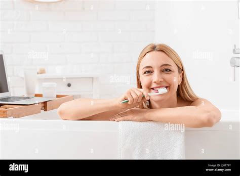 Beautiful Mature Woman Brushing Teeth While Taking Bath In Morning Stock Photo Alamy