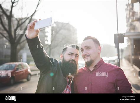 Gay Couple Taking Selfie On Pavement Stock Photo Alamy