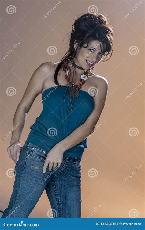 Gorgeous Brunette Model Poses In A Studio Environment Against A Colorful Background Stock Image