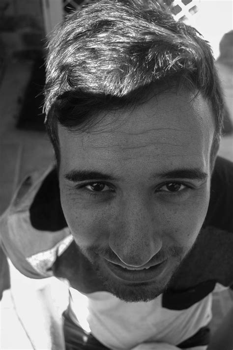 A Black And White Photo Of A Man With A Bow Tie Smiling At The Camera
