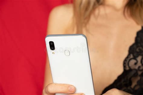 Naked Girl In Lingerie With Phones In Her Hands On The Bed Working As A Web Model Web Model