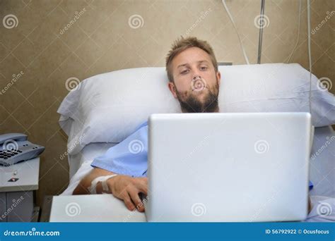 Young Man In Hospital Room In Bed Using Internet Researching Info On ...
