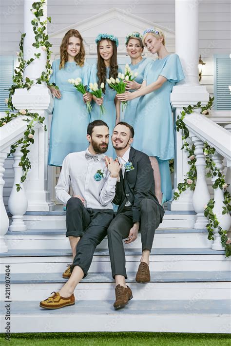 Gay Marriage Two Handsome Grooms Holding Hands While Sitting Cheek To Cheek On Front Porch