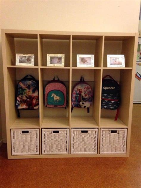 A Bookcase With Baskets And Backpacks On It In A Room Next To A Wall