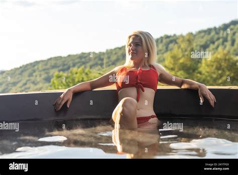 Woman Relaxing In Hot Bath Outdoors Enjoying Thermal Spa At Mountains Summer Holidays In The