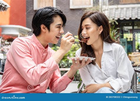 Young Asian Man Feeding Happy Girlfriend With Tasty Chocolate Cake