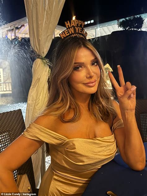 Lizzie Cundy Puts On A Busty Display In A Plunging Red Hot Swimsuit In Barbados After