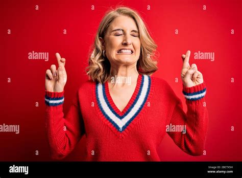 Middle Age Beautiful Blonde Woman Wearing Casual Sweater Over Isolated Red Background Gesturing