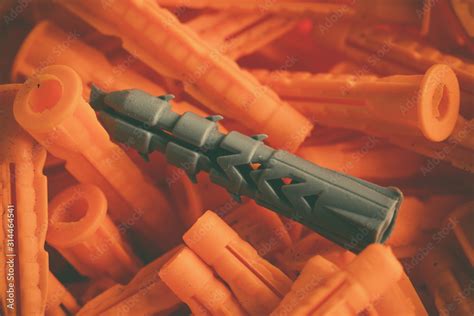 Plastic Dowel Gray Dowel On A Pile Of Orange Dowels Construction