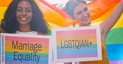 A Lesbian Couple Waves A Rainbow Flag A Symbol Of Homosexuality During A Pride Parade Stock