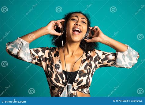 Beautiful African American Woman With Afro Hair And Big Headphones