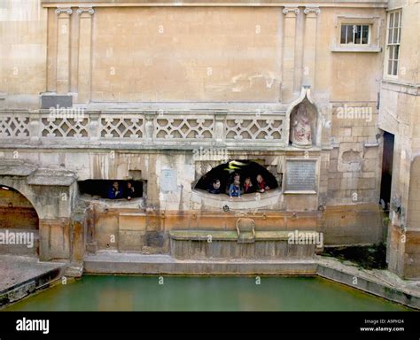 Visitors viewing the Roman baths in Bath England Stock Photo - Alamy