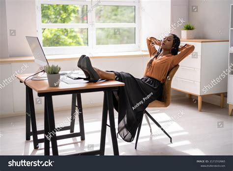 Woman Feet Up On Desk