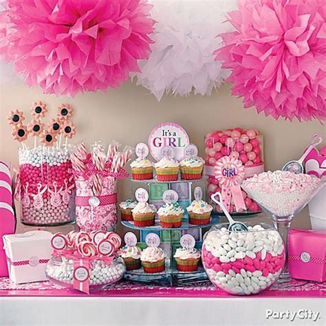 A Table Topped With Lots Of Pink And White Desserts Next To Cupcakes