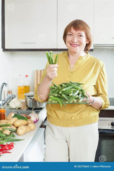 Smiling Mature Housewife Cooking Vegetables Stock Photo Image Of Furniture Vegetarian