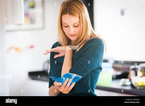 Woman Using A Hot Cold Gel Pack Treatment To Releive Pain Stock Photo Alamy