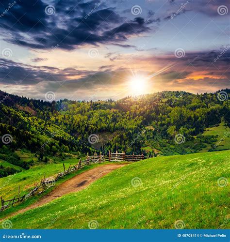 Fence On Hillside Meadow In Mountain At Sunset Stock Photo Image Of